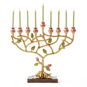 May include: A gold menorah shaped like a tree with pink pomegranate accents and green leaves. Two birds are perched on the base of the menorah.