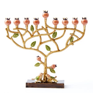 May include: A gold menorah shaped like a tree with pink berries and green leaves. Two birds are perched on the base of the menorah, which is made of wood.