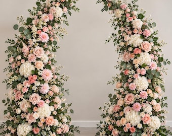 May include: Two large, curved floral arrangements featuring a dense mix of white hydrangeas, soft pink roses, light pink dahlias, and various green eucalyptus leaves. The structures are shaped like tall, sweeping arches of flowers.