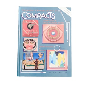 May include: A blue book titled "Collector's Encyclopedia of Compacts: Carryalls & Face Powder Boxes" with updated values. The cover features images of vintage compacts with various designs, including a pink compact with a winged logo, a round compact with a woman's face, a compact with an American flag, and a geometric compact.
