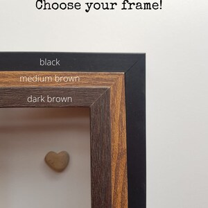 May include: Choose your frame! Three frame options are shown: black, medium brown, and dark brown. A small heart-shaped stone is in the center of the frame.