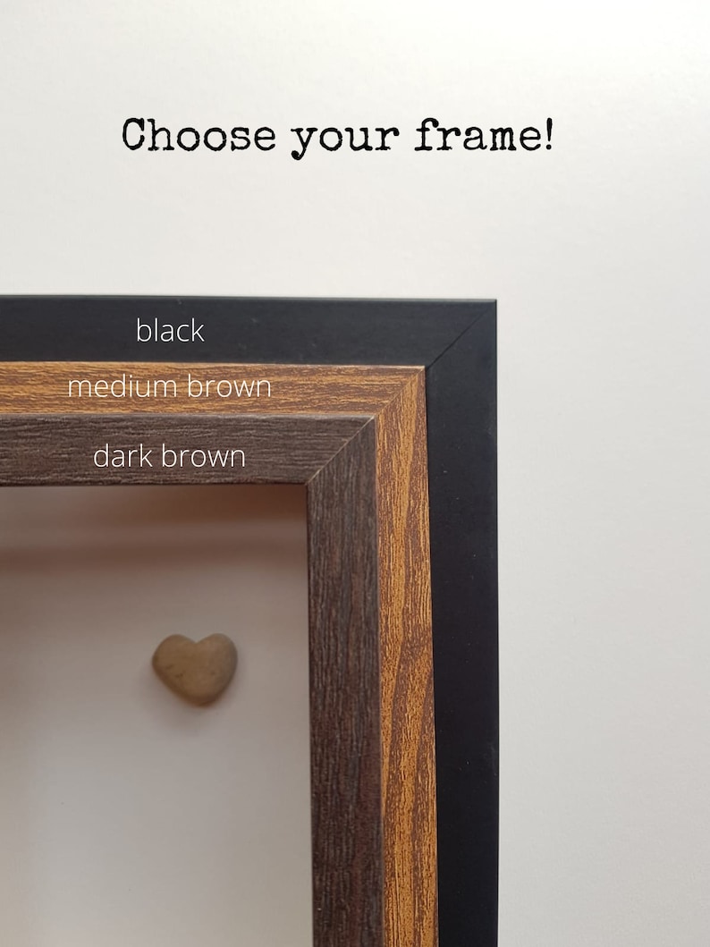 May include: Choose your frame! Three frame options are shown: black, medium brown, and dark brown. A small heart-shaped stone is in the center of the frame.