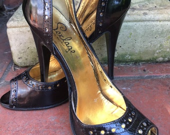May include: Black peep-toe heels with gold lining and a gold label that reads "Sergio Rossi Made in Italy".