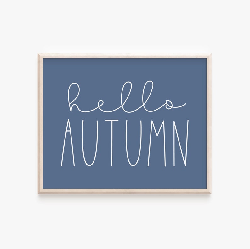 May include: A blue framed print with white text that says "hello autumn".