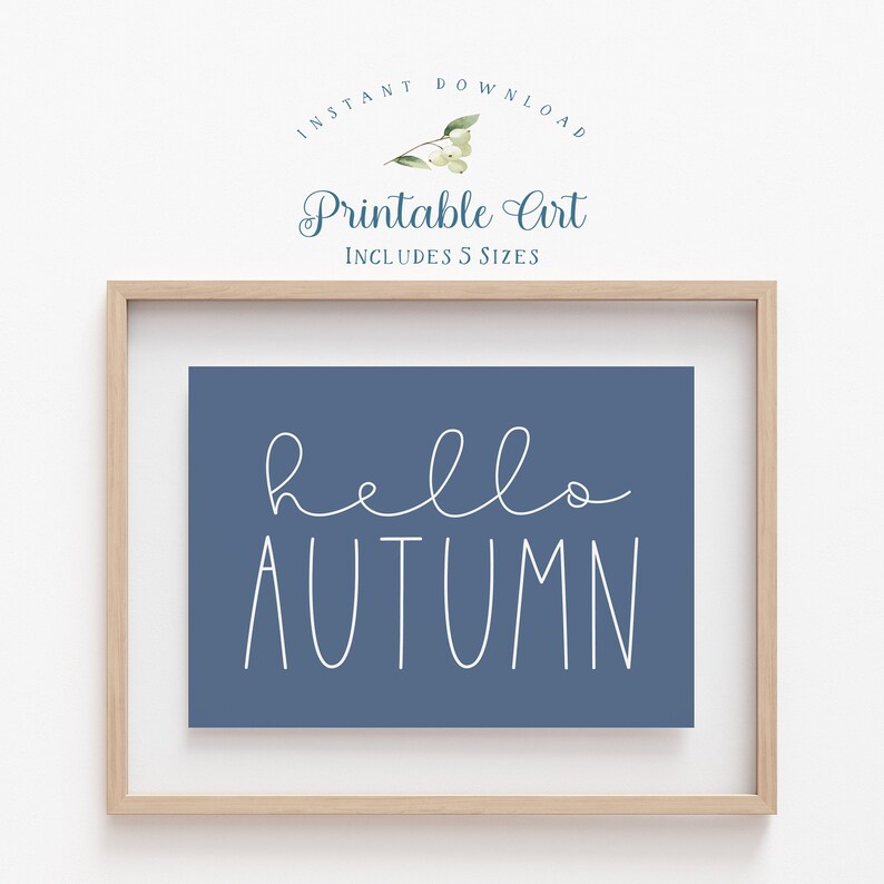 May include: A printable art print with the text "hello autumn" in white script on a blue background. The print is framed in a light wood frame.