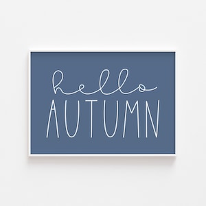 May include: A blue framed print with white text that reads "hello autumn".