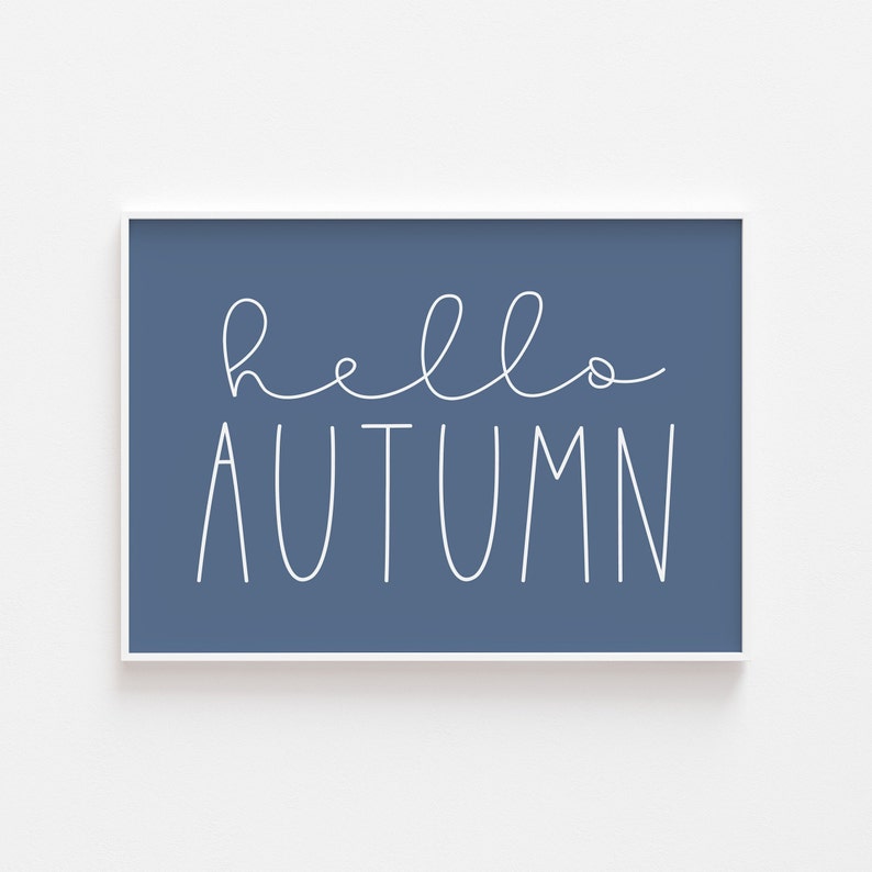 May include: A blue framed print with white text that reads "hello autumn".