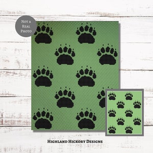 May include: A digital image of a green and black bear paw print pattern. The image is labeled "Not a Real Photo" and "Highland Hickory Designs".