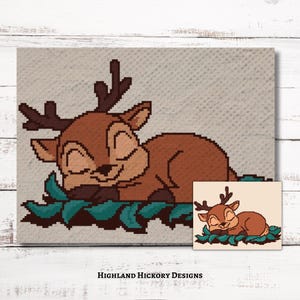 May include: A brown deer with closed eyes is sleeping on a bed of green leaves. The deer has large antlers. The image is a pixelated design.