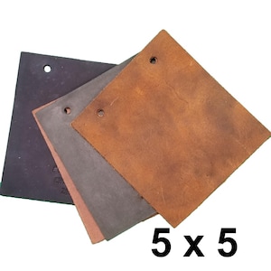 May include: Three square leather swatches in black, dark gray, and tan, each featuring a single punched hole near the top edge. The leather pieces are layered over one another, and the text 5 x 5 is printed in black in the lower right corner.