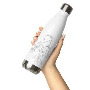 May include: White stainless steel water bottle with a black and white line drawing of a mountain range and the text "SOURCE AND SUMMIT".