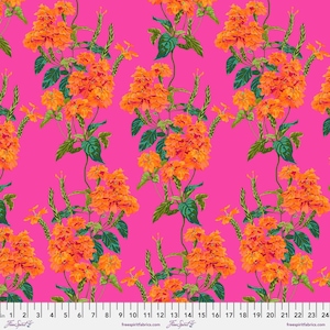 May include: A vibrant fabric pattern featuring orange floral clusters and green leaves against a bright pink background. The design includes vertical stems and smaller floral elements, creating a lively and colorful botanical print. The fabric is marked with a ruler in inches.