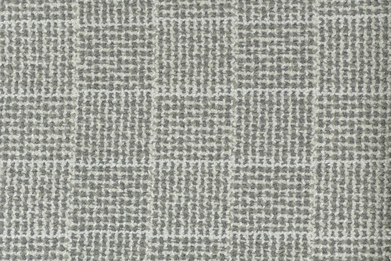 May include: A close-up of a grey and white woven fabric with a subtle checkered pattern.
