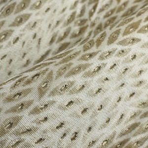 May include: A set of three ceramic mugs with a speckled, cream-colored glaze. Each mug features a different hand-painted floral design in shades of blue, green, and yellow. The mugs have a simple, rounded shape and a comfortable handle.