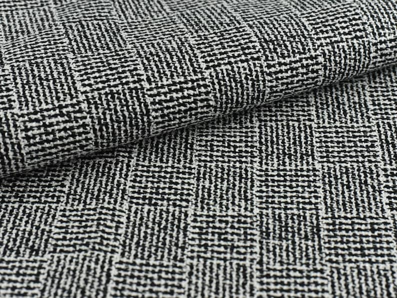 May include: Black and white fabric with a herringbone pattern. The fabric is woven with a textured surface.
