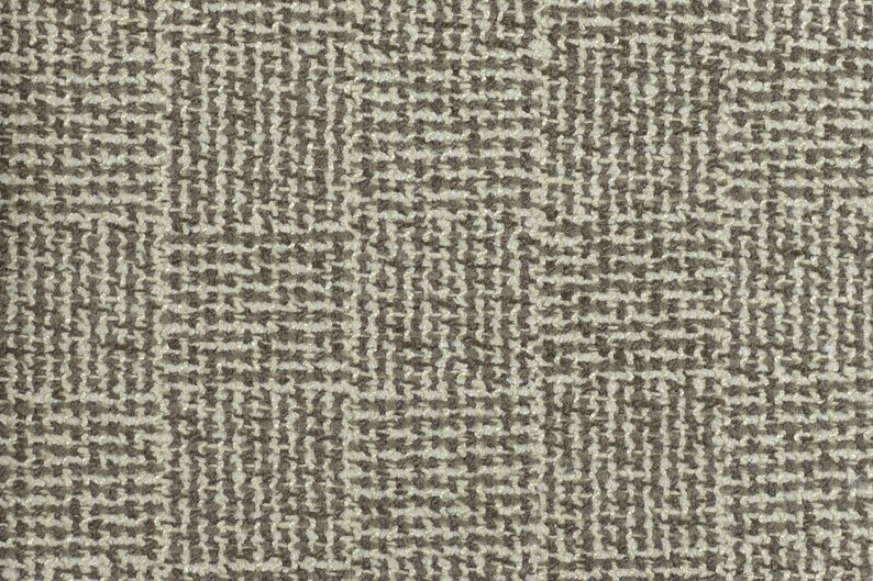 May include: A close-up of a brown and beige textured fabric with a geometric pattern.