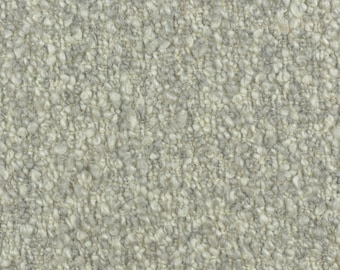 May include: Close-up of a light gray textured fabric with a fuzzy, nubby surface.