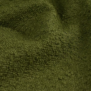 May include: Close-up of a textured green fabric with a soft, fuzzy surface.