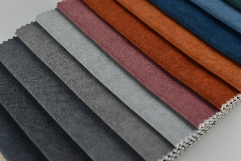 Puede incluir: Una colecci&oacute;n de muestras de tela en varios tonos de gris, azul, rojo, naranja y marr&oacute;n. Las muestras est&aacute;n dispuestas en un patr&oacute;n escalonado, con los tonos m&aacute;s oscuros en la parte inferior y los tonos m&aacute;s claros en la parte superior.