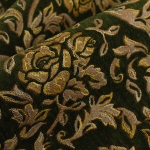 May include: Close-up of a dark green fabric with a repeating floral pattern. The design features gold and tan roses and leaves, creating a textured, elegant look. The fabric is likely used for upholstery or drapery.