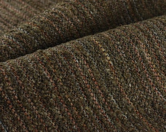 May include: Close-up of a textured fabric with a dark green, brown, and gray color scheme. The fabric has a woven appearance with a subtle striped pattern.