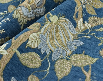 May include: Blue fabric with a floral pattern featuring a large flower with brown and blue petals, brown branches, and green leaves.