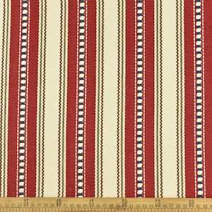 May include: Red and white striped fabric with a subtle pattern of small white circles and blue lines. The fabric is measured in inches.