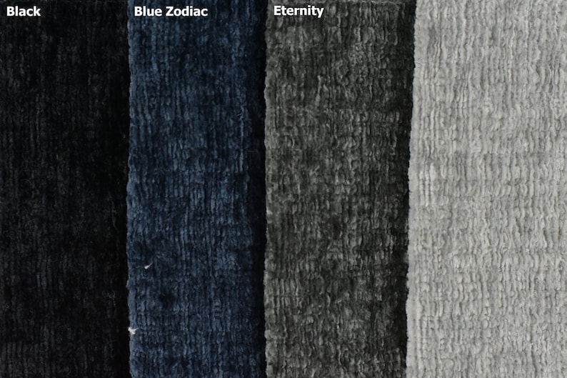 May include: Four fabric swatches in different colours: black, blue, grey, and light grey. The fabric has a textured, fuzzy appearance.