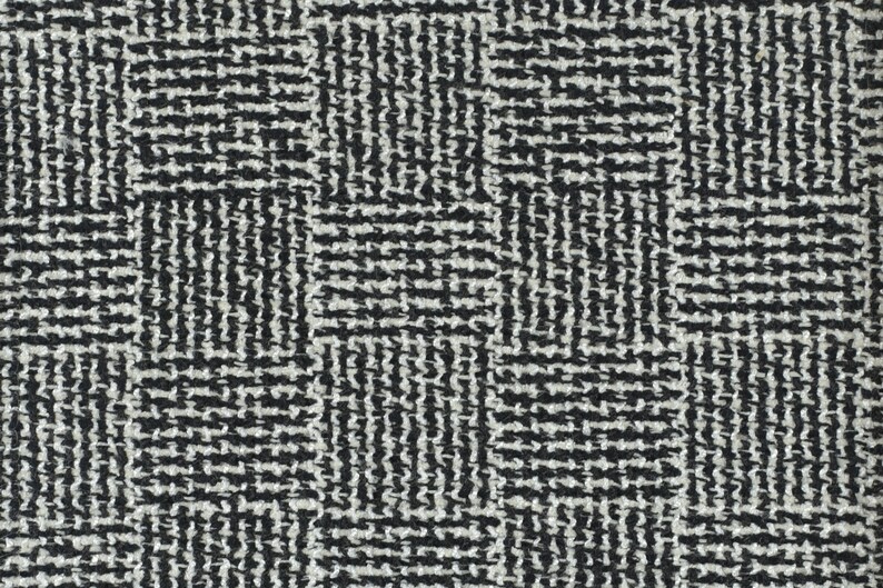 May include: Black and white geometric patterned fabric with a woven texture.