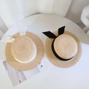 New, English Hepburn style bowknot raffia straw hat flat，  top holiday beach hat female， summer hat.Christmas Gift