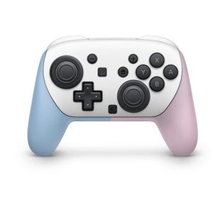 May include: A white and pastel-coloured video game controller. The controller has a white centre with black buttons and control sticks. The left side is light blue, and the right side is pink.