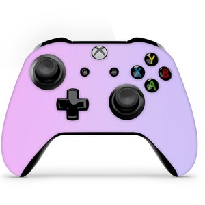May include: A purple and pink gradient Xbox controller with black buttons and a black directional pad.