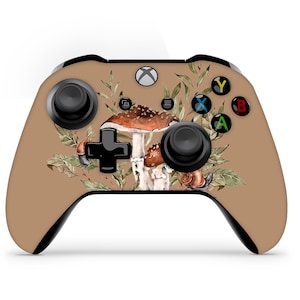 May include: A brown Xbox controller with a mushroom and leaf design. The controller has black buttons and a black D-pad.