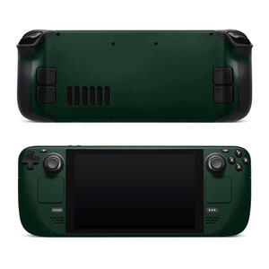 May include: A dark green handheld gaming device with a large screen, two joysticks, and a variety of buttons. The device has a textured surface and a sleek design.