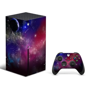 May include: A black Xbox Series X console and controller with a galaxy-themed skin. The console features a dark purple and pink nebula design with a small planet in the top left corner. The controller has the same design.