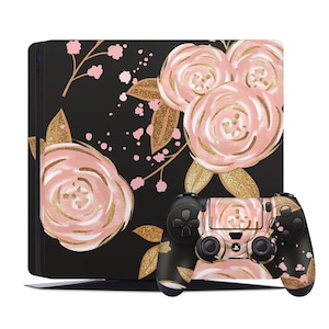 May include: A black PlayStation 4 console and controller with a floral skin. The skin features pink and gold roses on a black background.