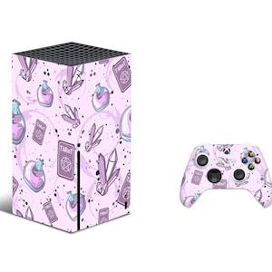 May include: A pink and purple Xbox Series X console and controller skin with a tarot card and potion design. The design features crystals, potions, and tarot cards with the word "Tarot" repeated throughout.