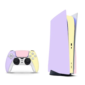 May include: A pastel-colored PlayStation 5 console with a matching controller. The console is light purple with a yellow and pink accent. The controller is light purple on the left side, pink in the middle, and yellow on the right side.