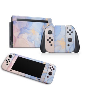 May include: A Nintendo Switch console and two controllers with a blue, pink, and gold marble design.