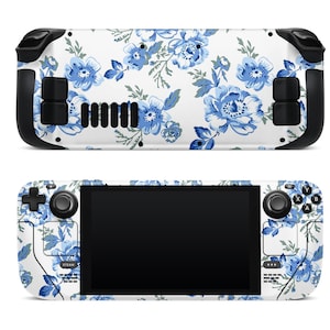 May include: A white handheld gaming device with a blue and white floral pattern. The device has a screen, buttons, and joysticks.