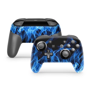 May include: A black Nintendo Switch controller with a blue and black flame design.