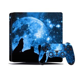 May include: A blue and black video game console skin with a full moon and wolf silhouettes against a starry night sky. The skin is designed for a Playstation 4 console and controller.
