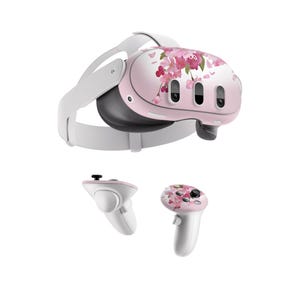 May include: A white virtual reality headset with a pink floral design. The headset has a strap that goes around the head and two controllers with the same floral design.