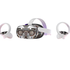 May include: VR headset with a silver and metallic design, featuring a detailed mechanical faceplate. The headset is accompanied by two white controllers, all set against a white background.
