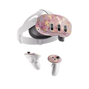May include: A white virtual reality headset with a pink and gold marble pattern. The headset comes with two white controllers, each with a pink and gold marble pattern.