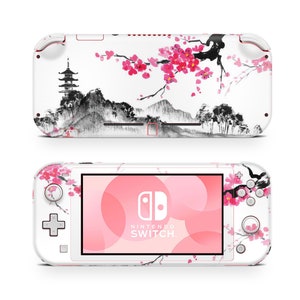 May include: White Nintendo Switch Lite console with a pink and black Japanese-inspired design featuring cherry blossoms and a pagoda. The console has the Nintendo Switch logo and text.
