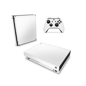 May include: White Xbox console and controller set. The console is rectangular with a black trim and the controller has black buttons and accents. The set is displayed on a white background.