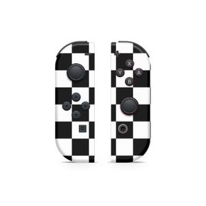 May include: A pair of black and white checkered Nintendo Switch Joy-Con controllers. The controllers have the standard button layout, including A, B, X, Y, and directional buttons.