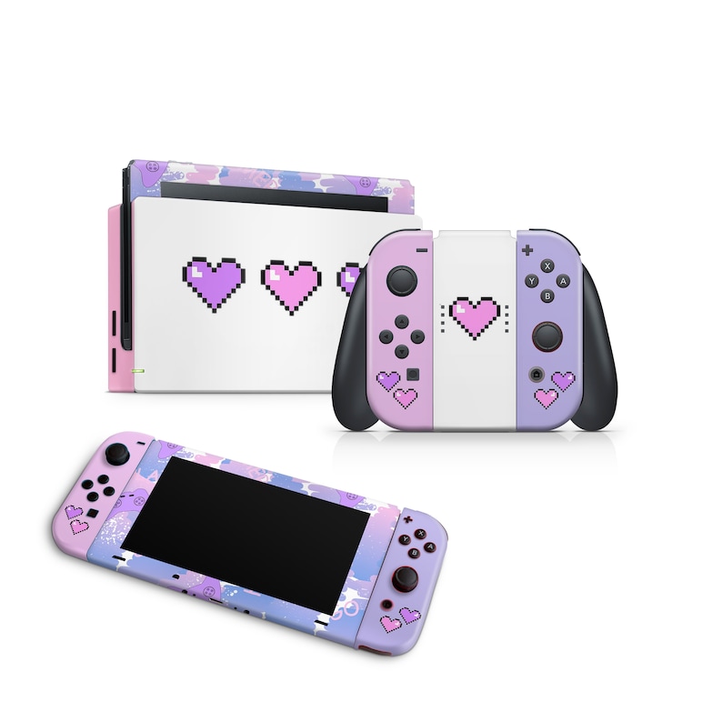 May include: A pink and purple Nintendo Switch console with a pixelated heart design. The console is shown with the Joy-Con controllers attached. The Joy-Con controllers are also pink and purple with pixelated hearts.