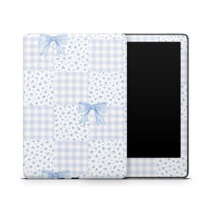 May include: A tablet case with a light blue and white patchwork design. The design includes gingham squares, floral patterns, and light blue bows. The tablet screen is black.
